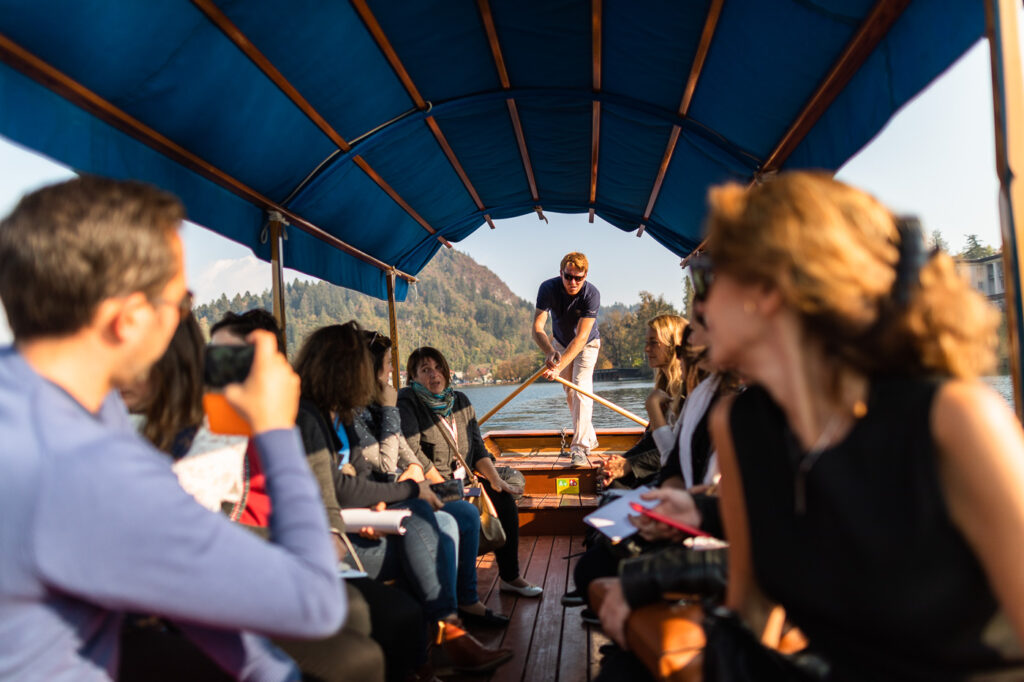 Corporate group on traditional pletna boat Lake Bled